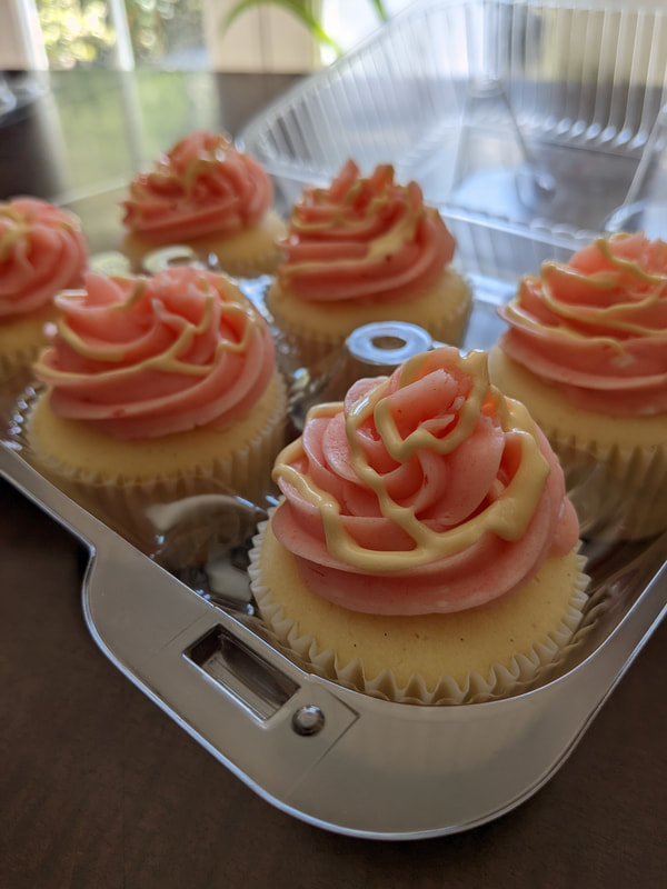 White Cake Cupcakes with Strawberry Buttercream Frosting and White Chocolate Drizzle